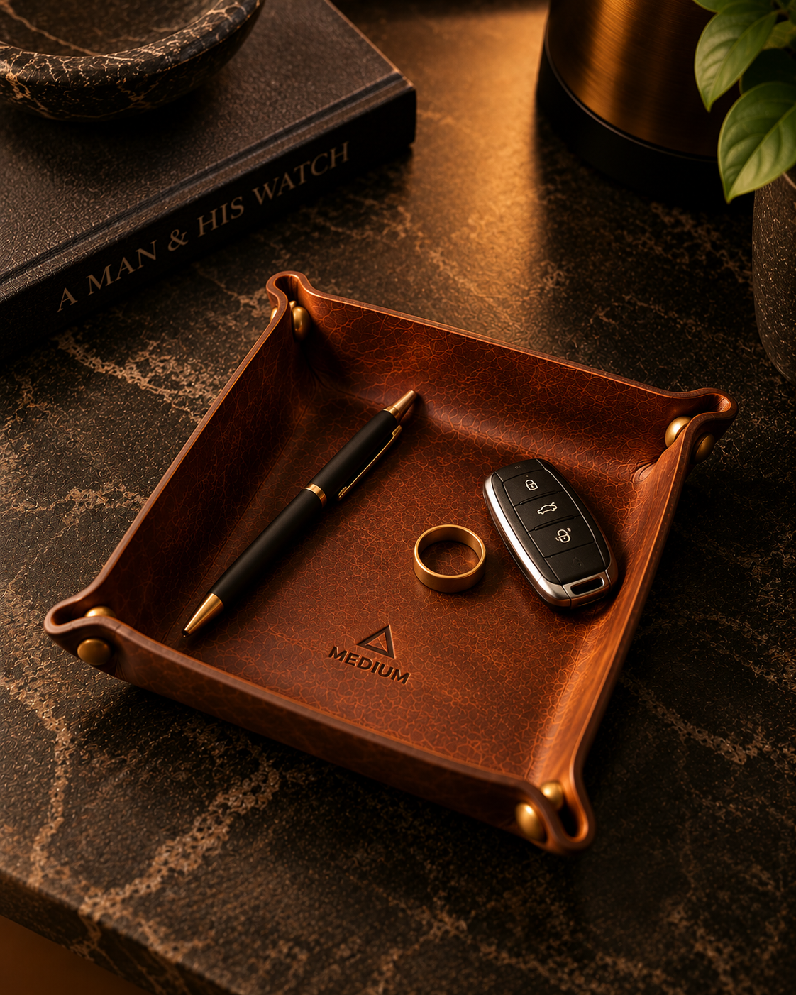 Heritage Brown valet tray holding a pen, ring and car key on a dark stone desk